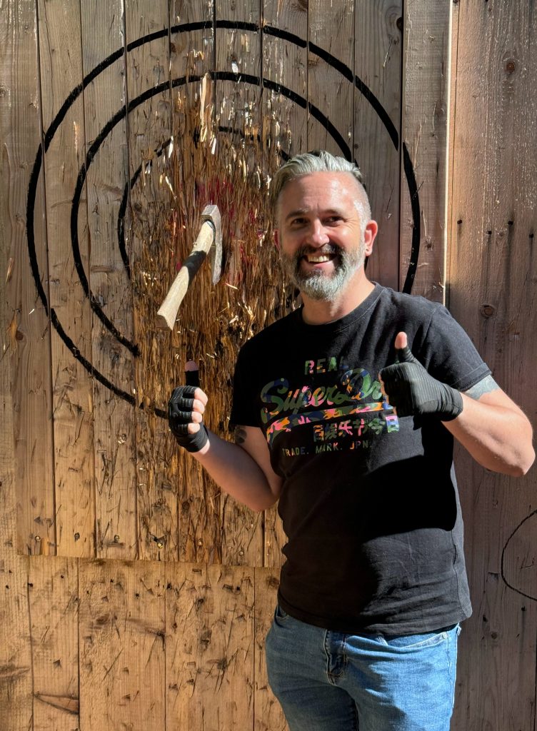 participant happy to get a bullseye when throwing their axe at wild cairns axe throwing.