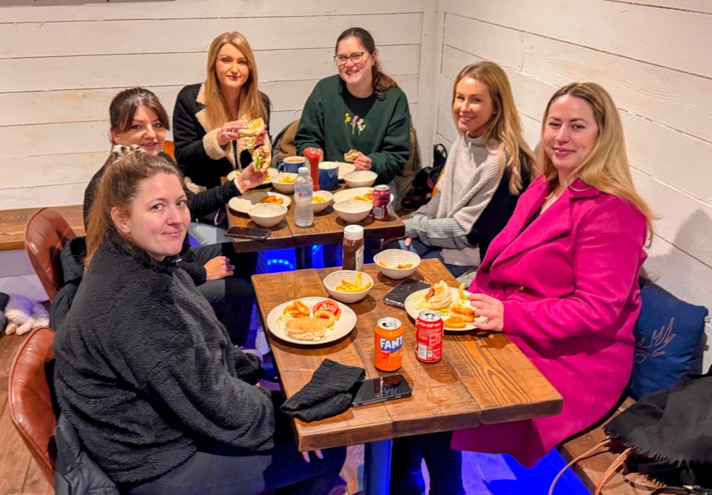 Adults enjoying food in the Wild Cairns Coffee shop.